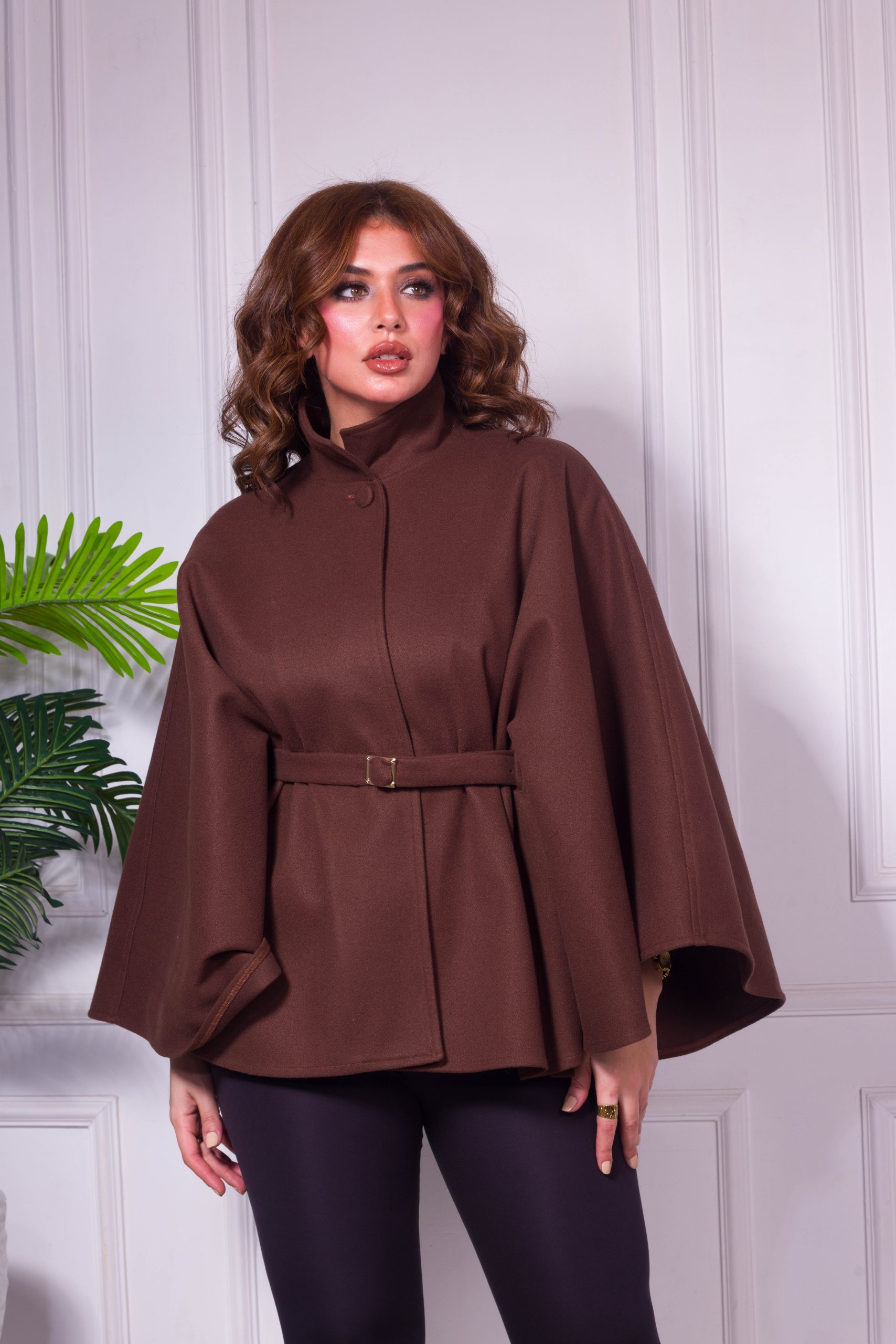 A cape with a belt featuring a gold buckle - Brown